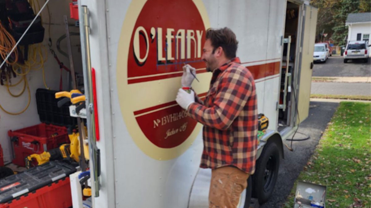 Aaron Leszczynski painting an O'Leary truck.