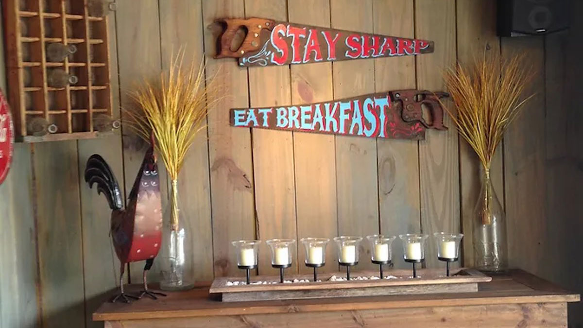 Hand painted saws on wall of house.